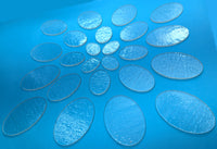 a blue table topped with lots of glass plates