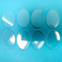 a set of six glass plates sitting on top of a blue surface