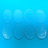 a set of six clear circles sitting on top of a blue surface