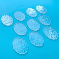 a group of oval plastic discs sitting on top of a blue surface