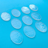 a group of oval plastic discs sitting on top of a blue surface