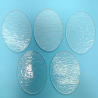 four circular glass plates on a blue background