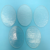 four circular glass plates on a blue background